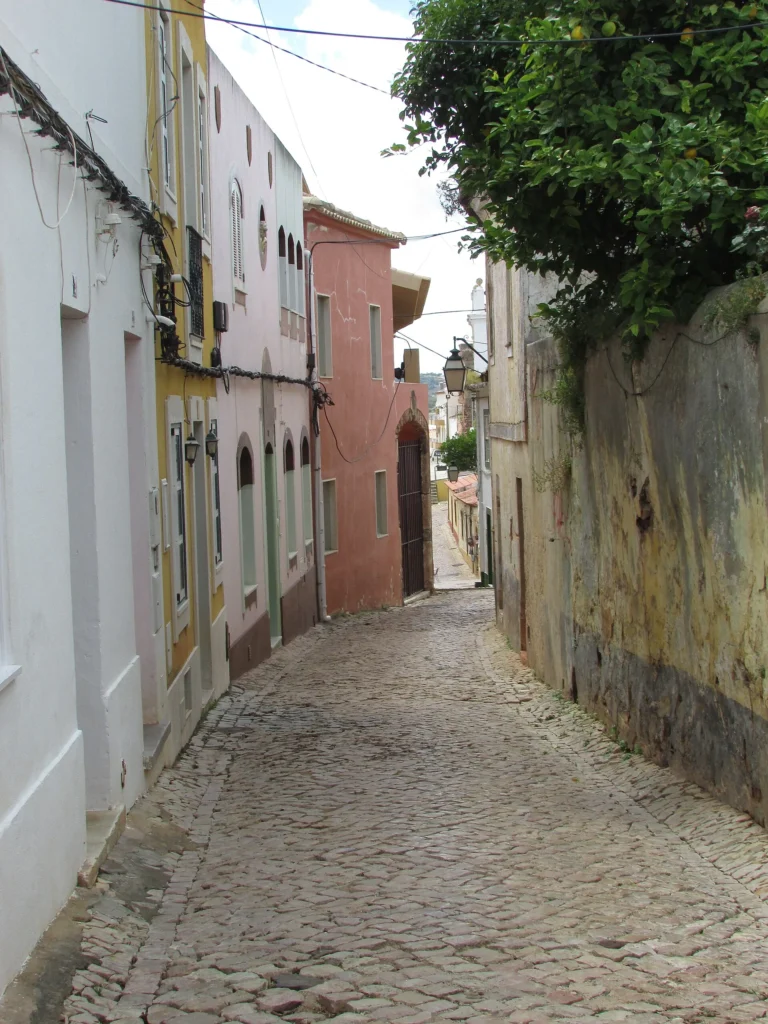 Cobblestone street in Silves with traditional buildings along Rua da Porta de Loulé.